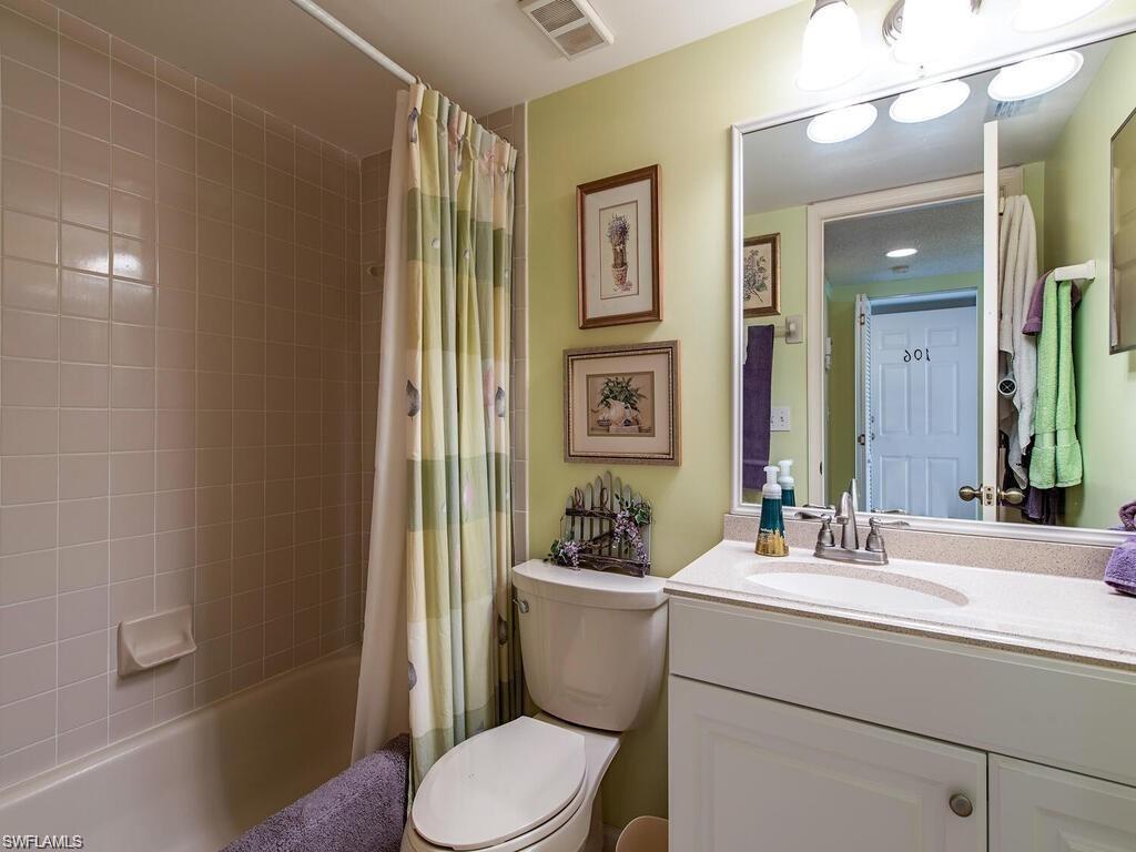 5932 Cranbrook Way, Unit C106 Naples, FL 34112 - Photo 9 of 13 Bathroom featuring vanity, toilet, and shower / tub combo with curtain