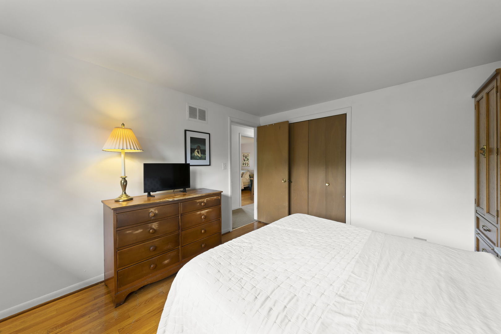 18522 Dixie Highway Homewood, IL 60430 - Photo 15 of 23 a bedroom with a bed and a flat screen tv on a dresser