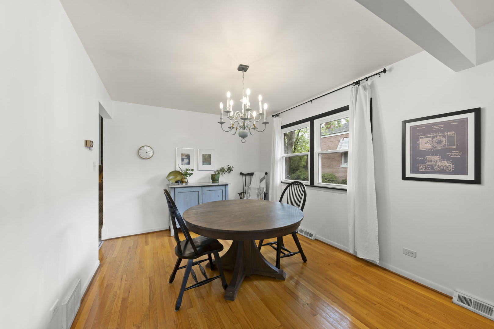 18522 Dixie Highway Homewood, IL 60430 - Photo 4 of 23 a dining room with furniture a chandelier and wooden floor