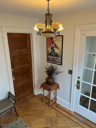 a view of a hallway with wooden floor and windows