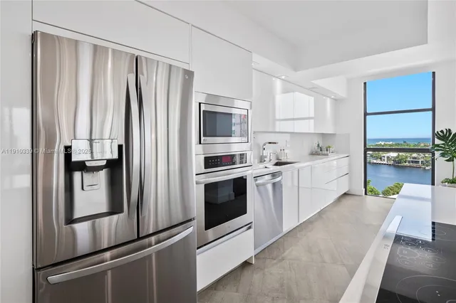 a kitchen with stainless steel appliances and white cabinets
