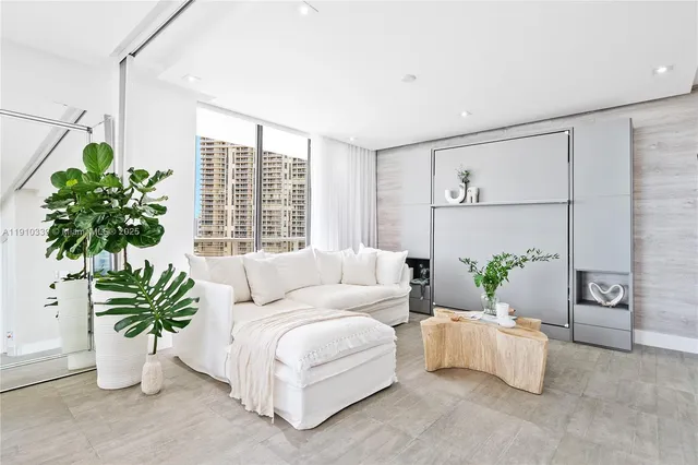 a living room with furniture and a potted plant