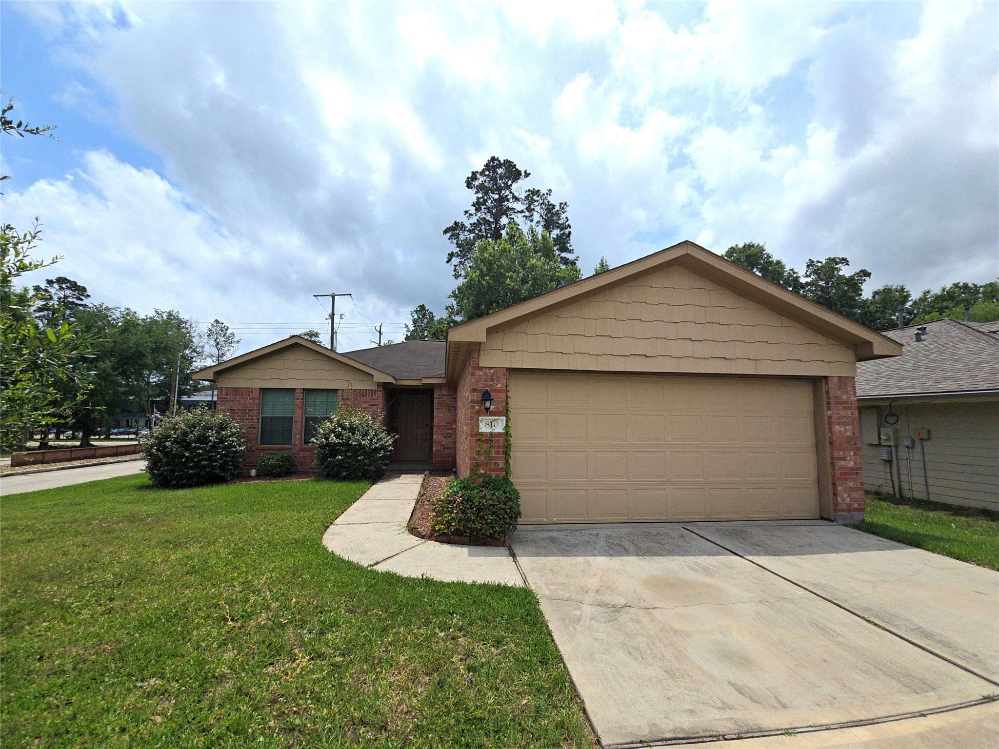 810 Lightningbug Lane Conroe, TX 77301 - Photo 23 of 27 a front view of a house with a yard and garage