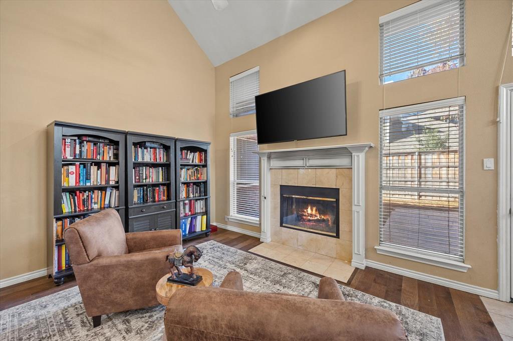 14633 Lakecrest Drive Addison, TX 75001 - Photo 5 of 14 a living room with fireplace furniture and a flat screen tv