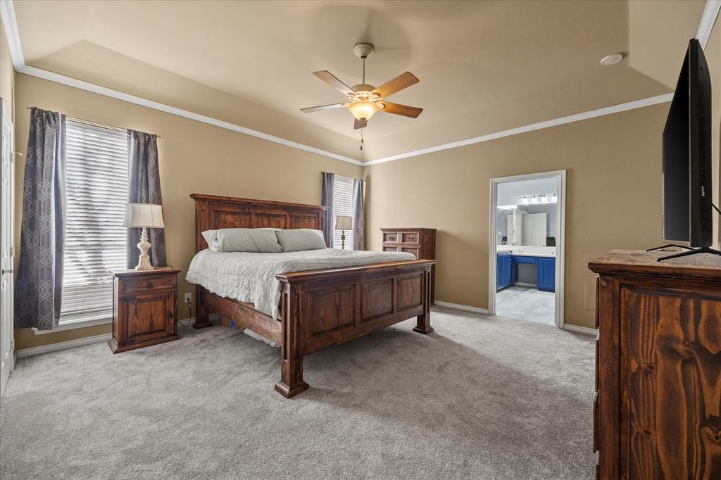 14633 Lakecrest Drive Addison, TX 75001 - Photo 7 of 14 a bedroom with a bed and a flat tv screen on dresser