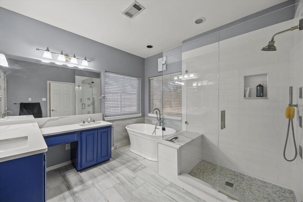 14633 Lakecrest Drive Addison, TX 75001 - Photo 8 of 14 a bathroom with a double vanity sink a toilet a mirror and shower