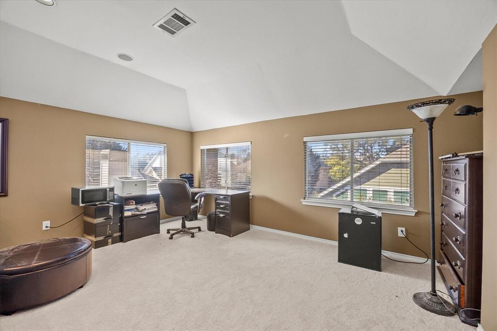 14633 Lakecrest Drive Addison, TX 75001 - Photo 10 of 14 a living room with furniture a large window and gym equipment