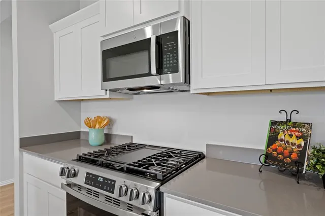 a stove top oven sitting inside of a kitchen