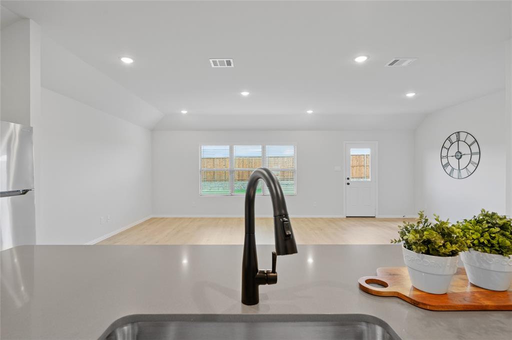 610 Ridgewood Drive Van Alstyne, TX 75495 - Photo 16 of 34 a vase of flowers sitting on a table