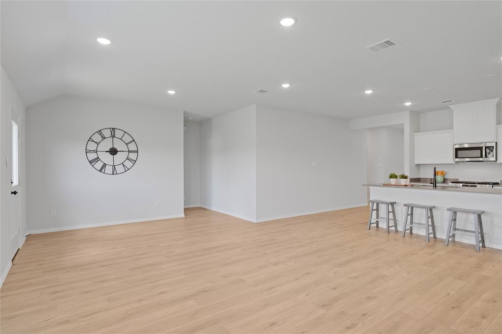 610 Ridgewood Drive Van Alstyne, TX 75495 - Photo 21 of 34 a view of kitchen with kitchen island stainless steel appliances refrigerator stove and white cabinets