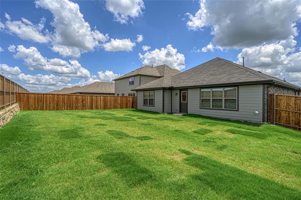 610 Ridgewood Drive Van Alstyne, TX 75495 - Photo 28 of 34 a view of a house with backyard and garden