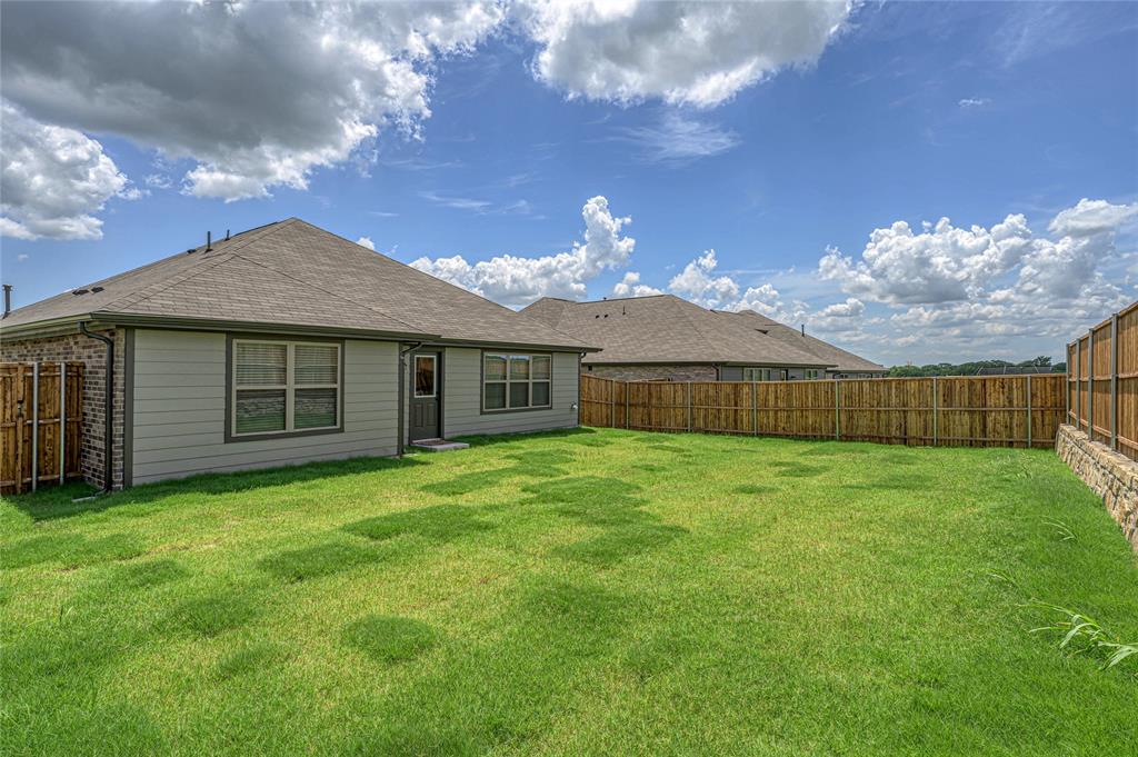 610 Ridgewood Drive Van Alstyne, TX 75495 - Photo 29 of 34 a view of a house with a backyard