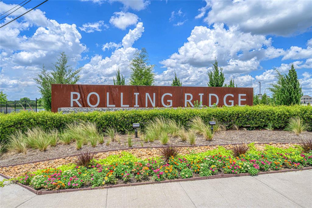 610 Ridgewood Drive Van Alstyne, TX 75495 - Photo 32 of 34 a sign that is sitting in front of flowers