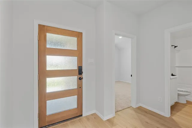 a view of an empty room and wooden floor