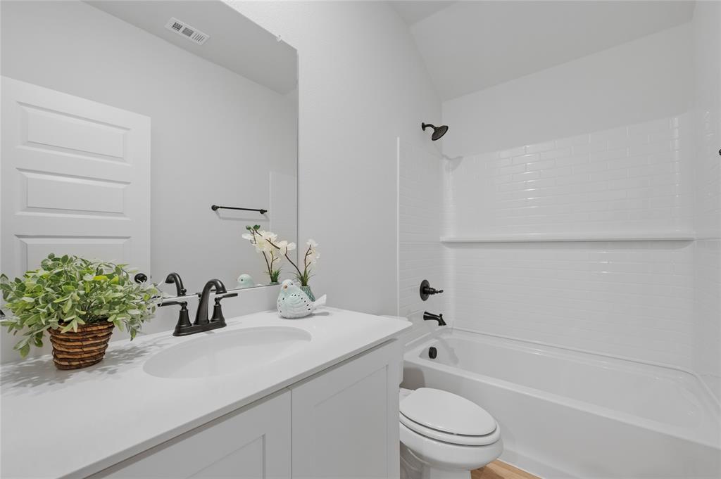 610 Ridgewood Drive Van Alstyne, TX 75495 - Photo 9 of 34 a bathroom with a sink a toilet and shower