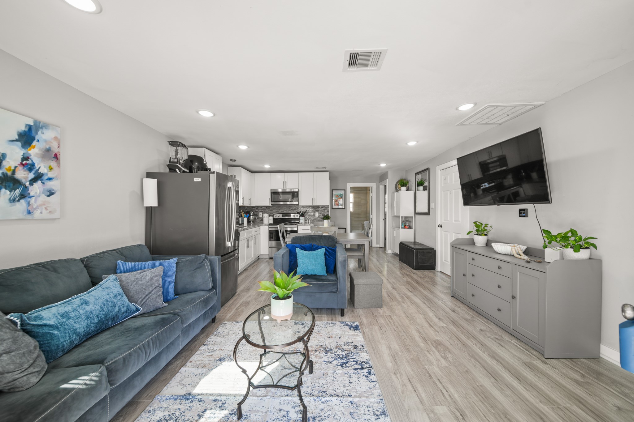 a living room with furniture and a flat screen tv