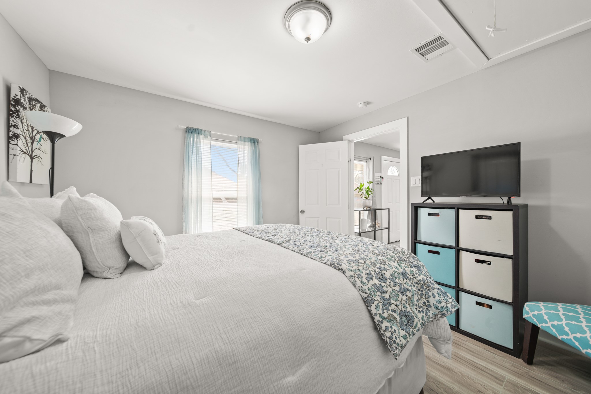 5605 Colfax Street Houston, TX 77020 - Photo 12 of 21 a bedroom with a bed television on desk and a window