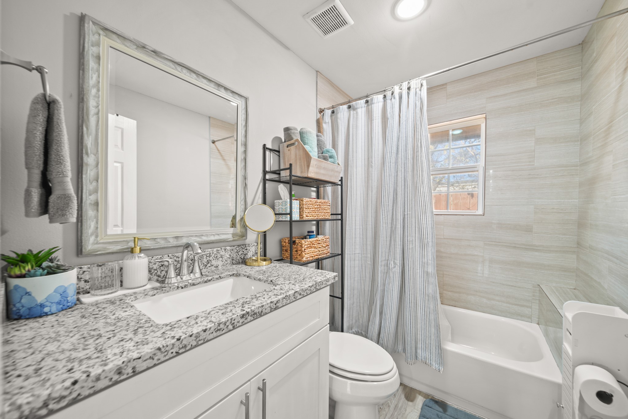 5605 Colfax Street Houston, TX 77020 - Photo 14 of 21 a bathroom with a granite countertop sink toilet and shower