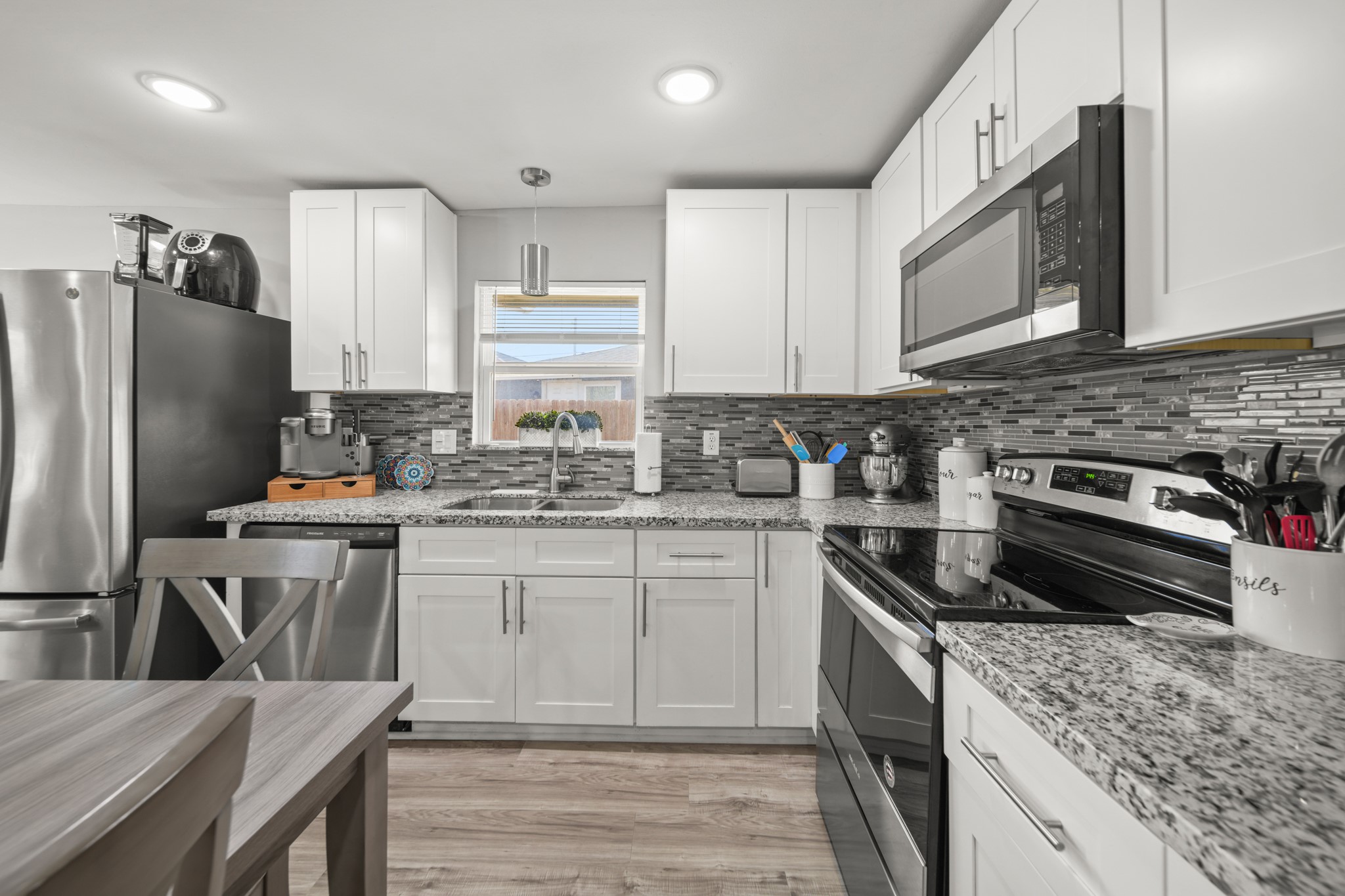 5605 Colfax Street Houston, TX 77020 - Photo 4 of 21 a kitchen with stainless steel appliances granite countertop a stove refrigerator sink and microwave