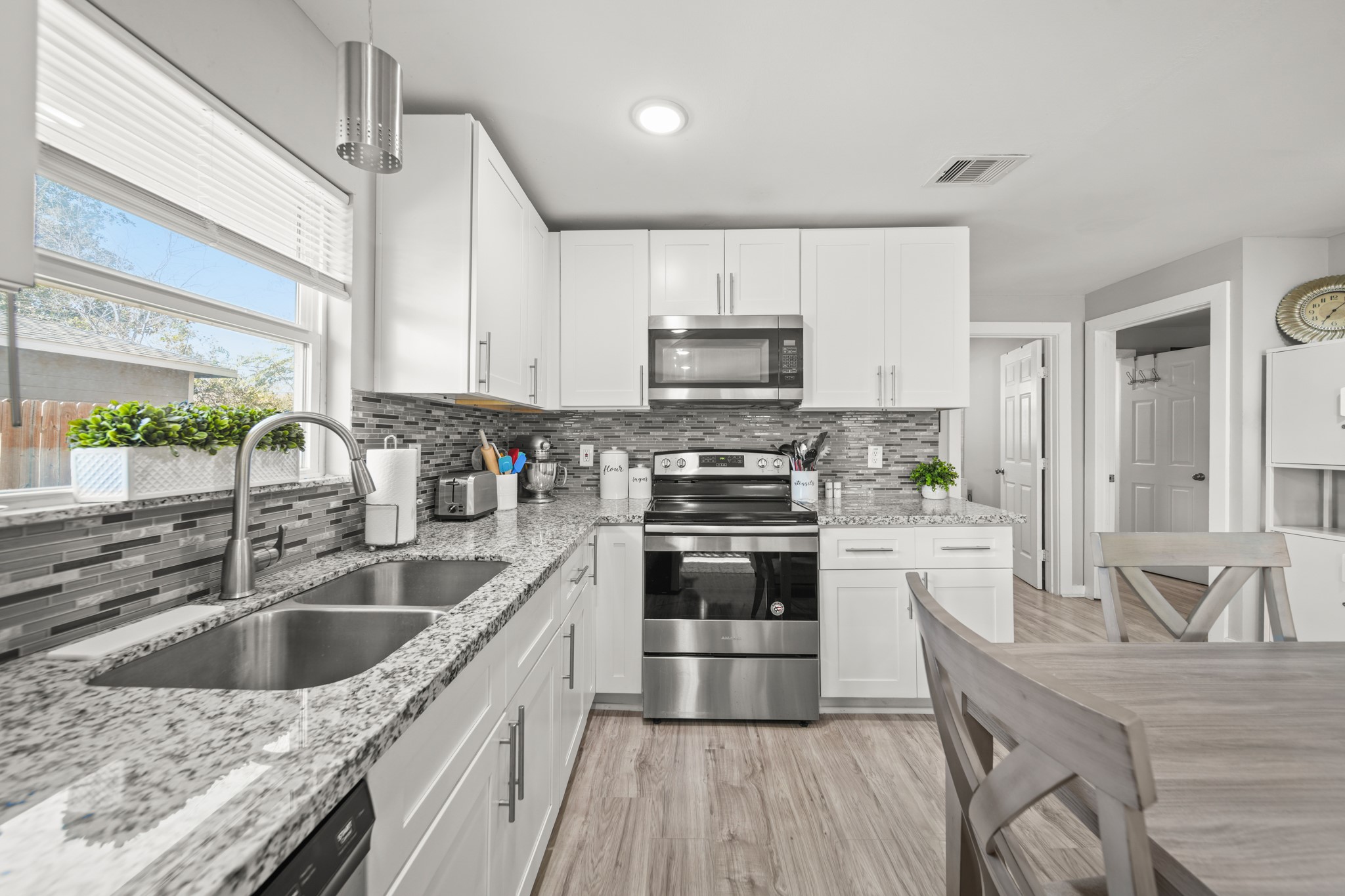 5605 Colfax Street Houston, TX 77020 - Photo 5 of 21 a kitchen with kitchen island granite countertop a sink appliances cabinets and a counter top space