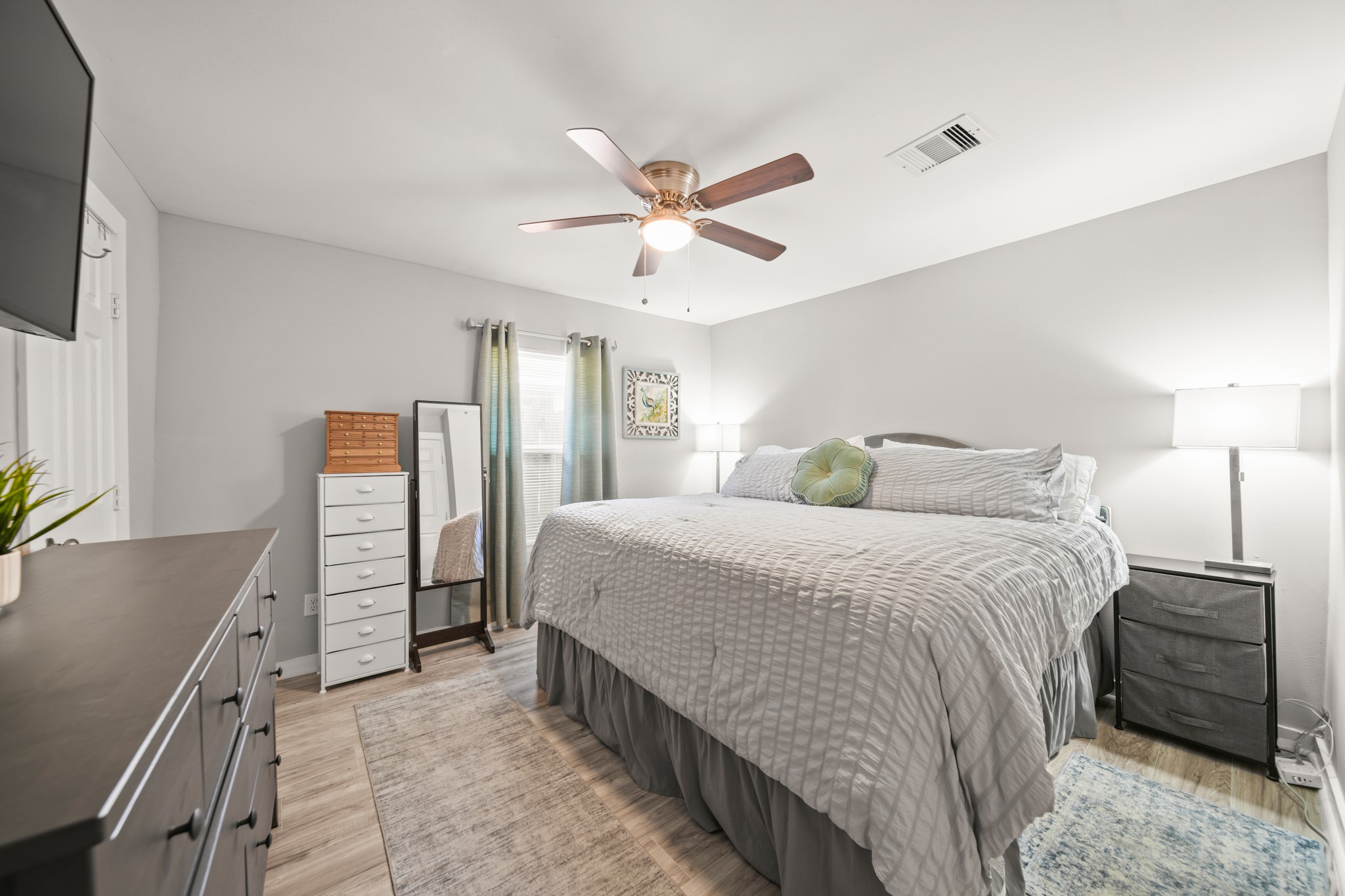 5605 Colfax Street Houston, TX 77020 - Photo 7 of 21 a bedroom with a bed and a flat tv screen on dresser