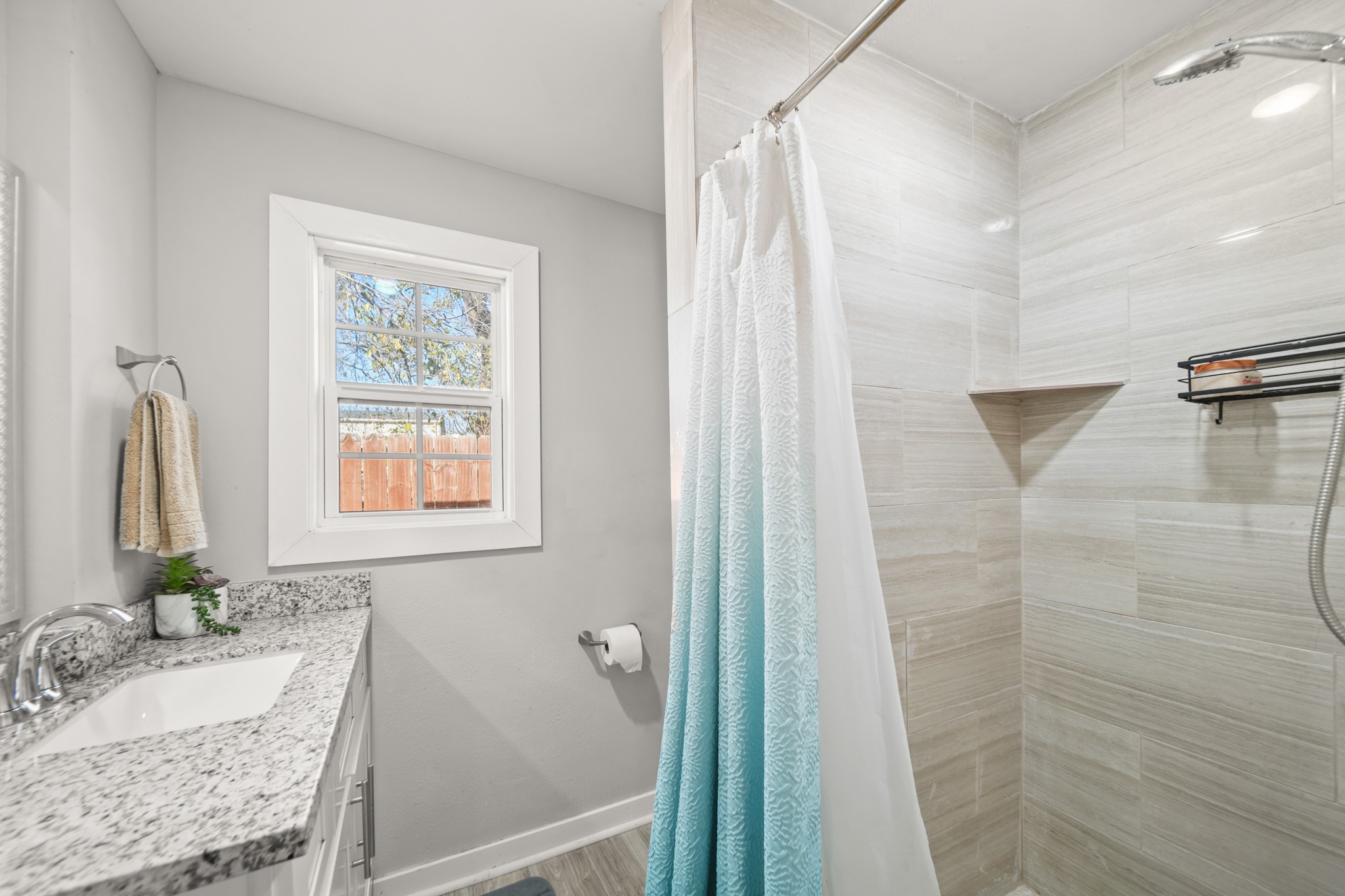 5605 Colfax Street Houston, TX 77020 - Photo 10 of 21 a bathroom with a granite countertop sink and a mirror