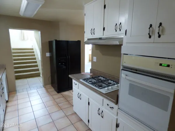 a kitchen with cabinets and appliances