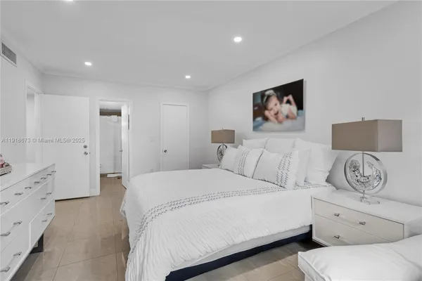 a spacious bedroom with a bed and a couch