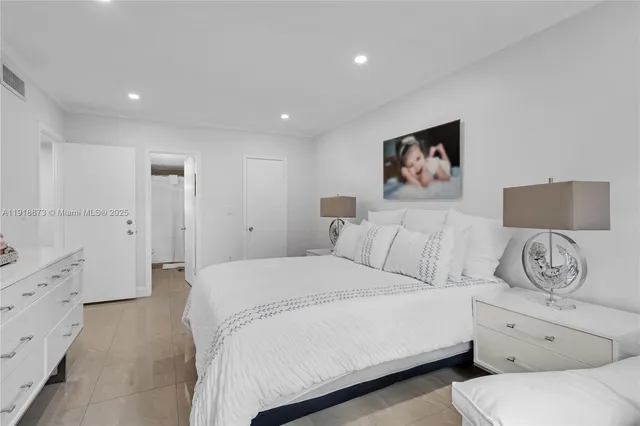 a spacious bedroom with a bed and a couch