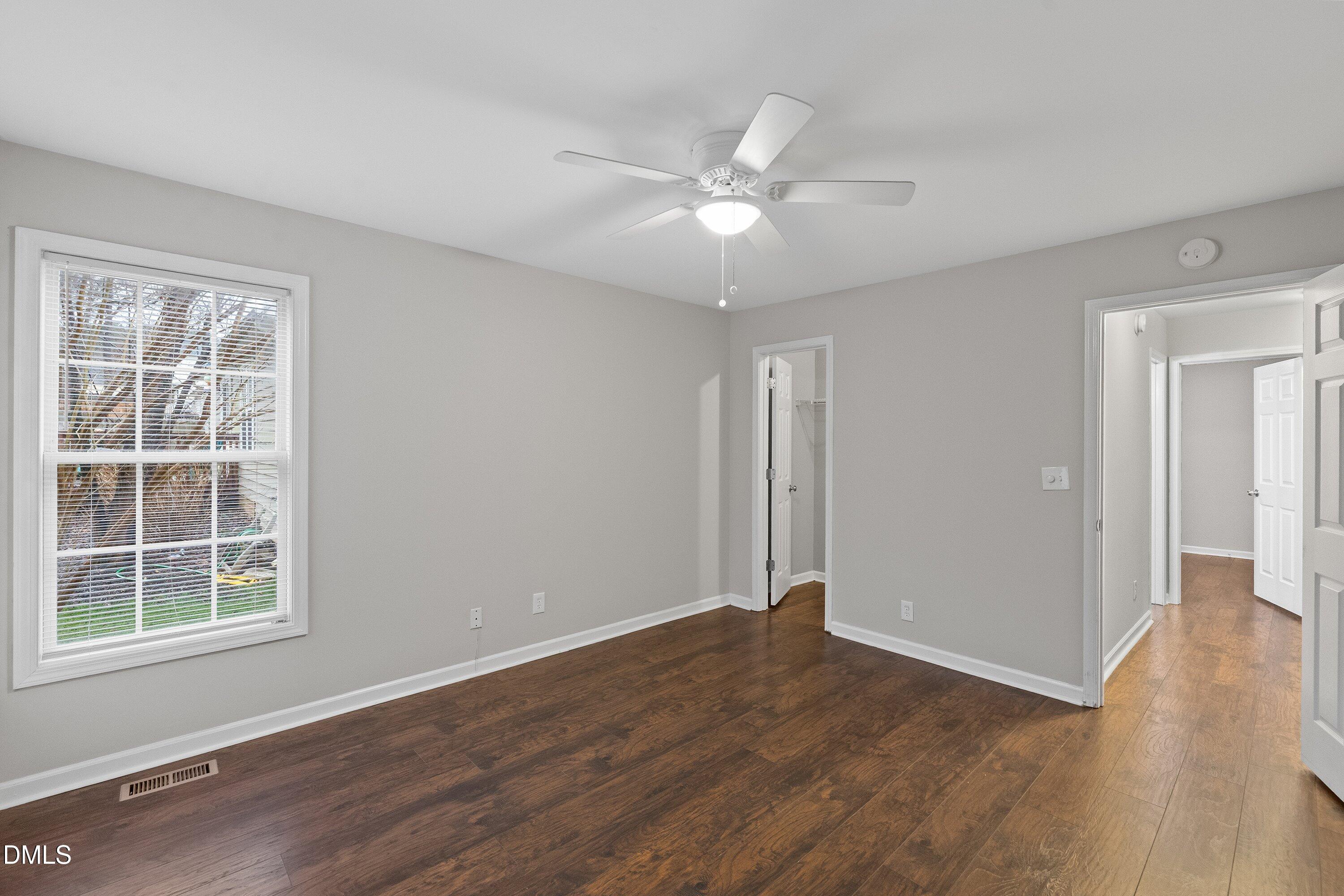 140 Melksham Road Wake Forest, NC 27587 - Photo 25 of 34 a view of an empty room with wooden floor and a window