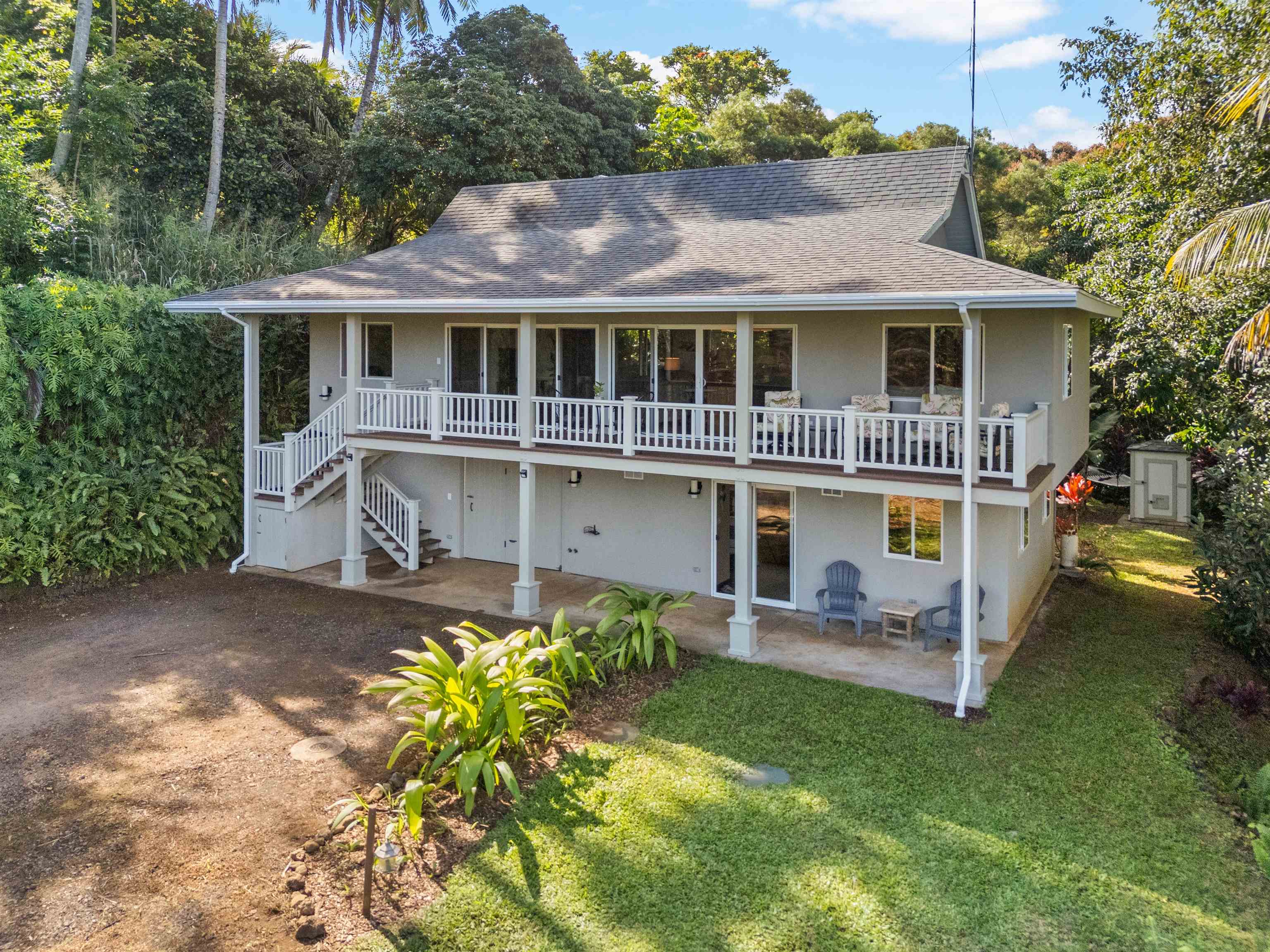 a front view of a house with a yard table and chairs