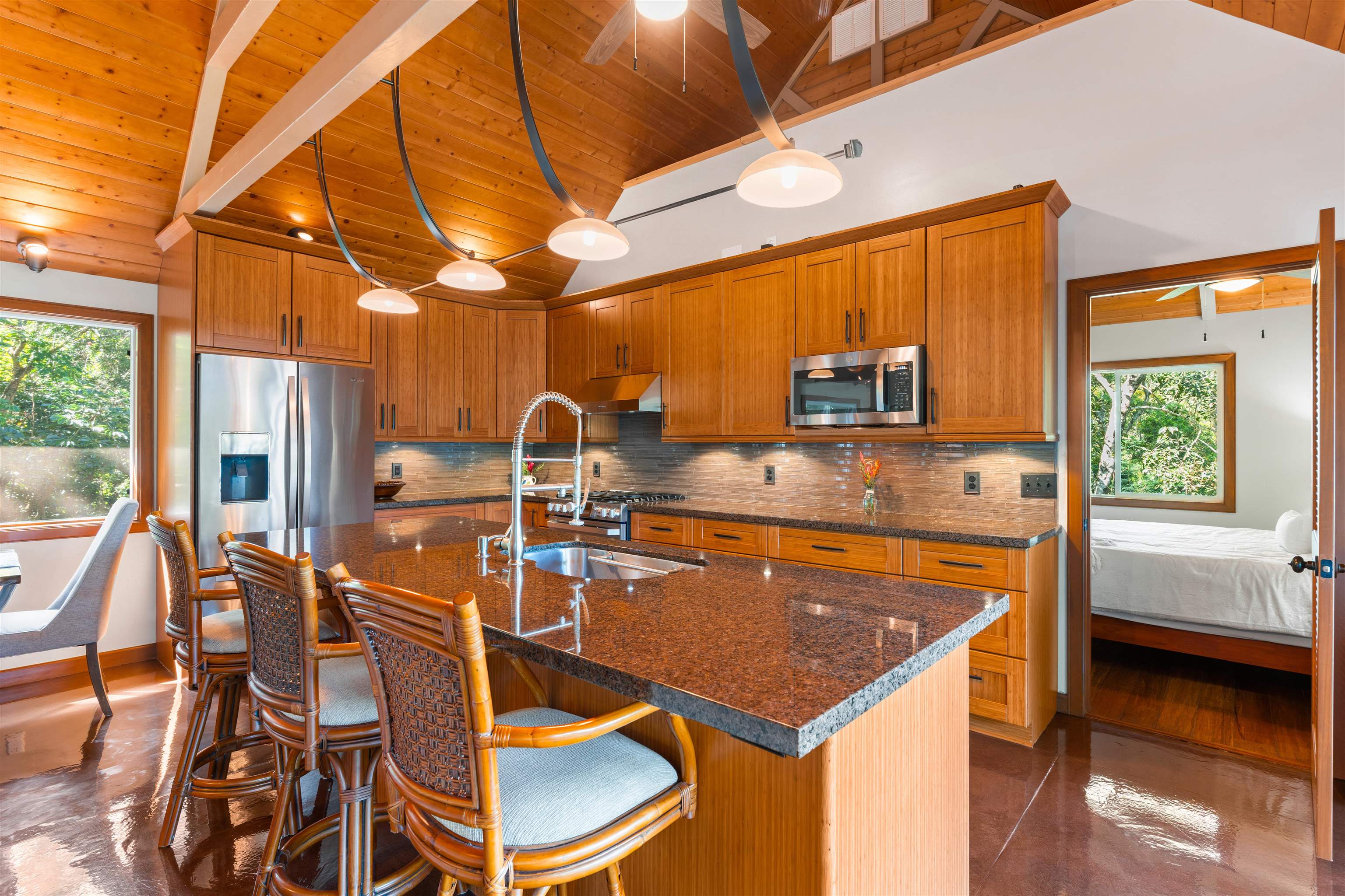 655 Kulike Road, Unit B Haiku, HI 96708 - Photo 13 of 38 a kitchen with a table chairs and a stove