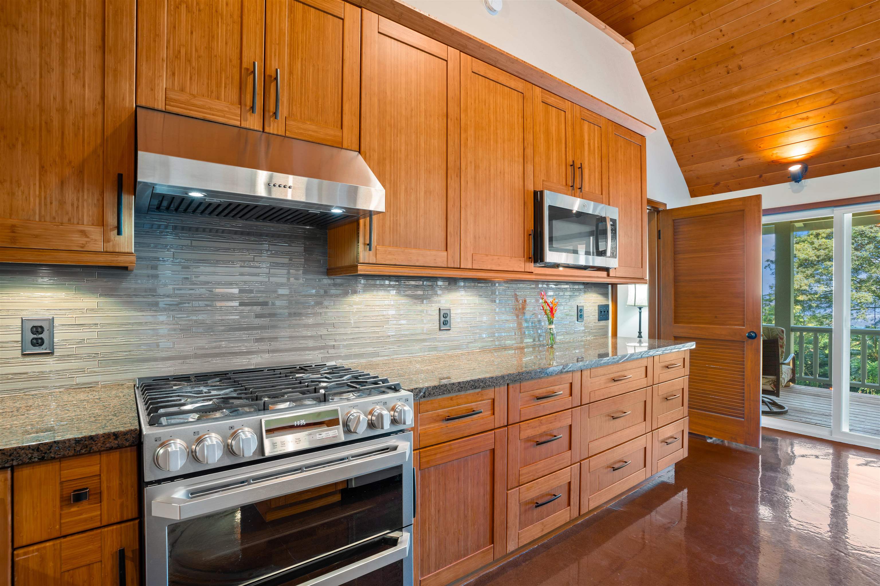 655 Kulike Road, Unit B Haiku, HI 96708 - Photo 15 of 38 a kitchen with granite countertop wooden cabinets and stainless steel appliances