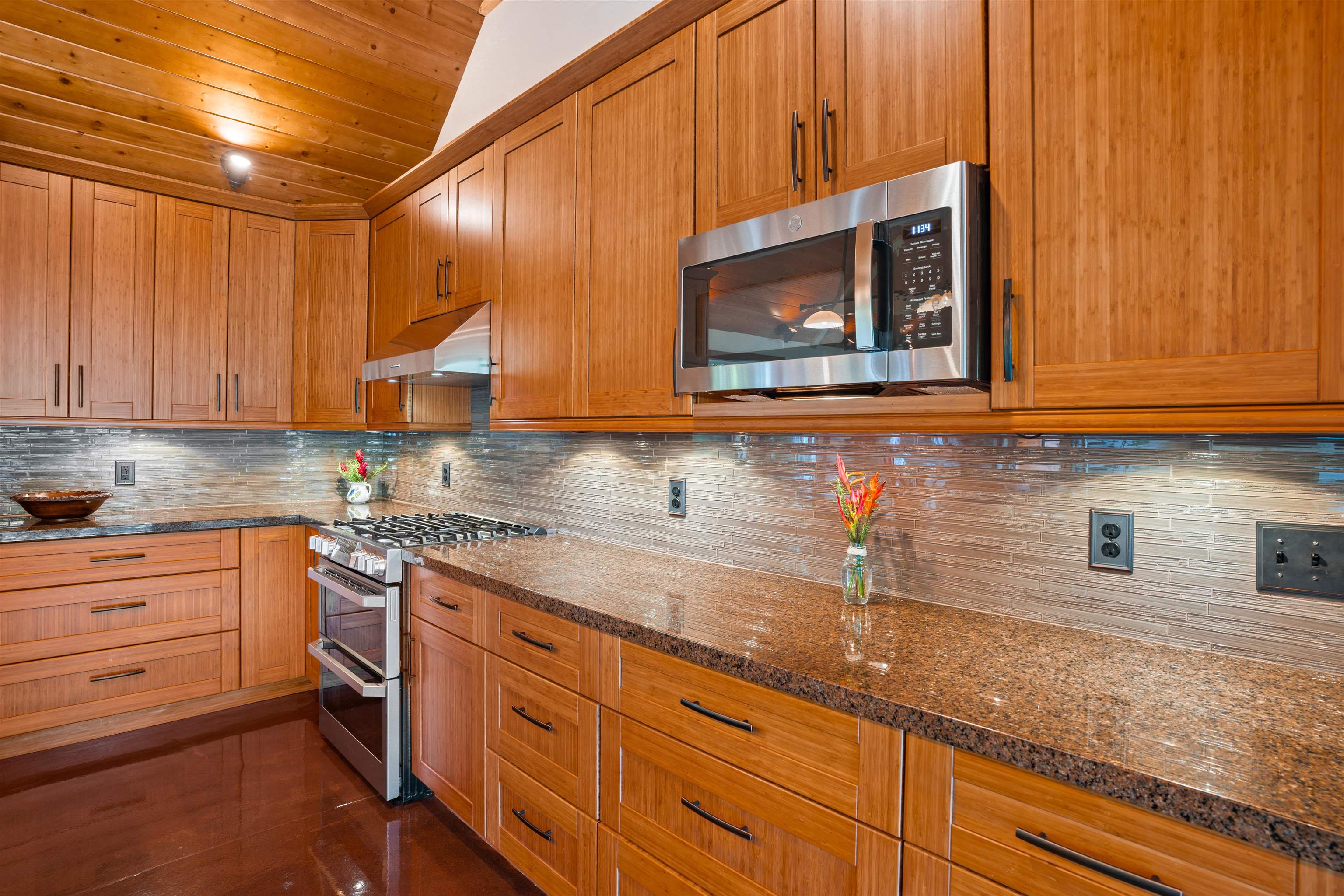 655 Kulike Road, Unit B Haiku, HI 96708 - Photo 16 of 38 a kitchen with stainless steel appliances granite countertop a sink a stove and cabinets