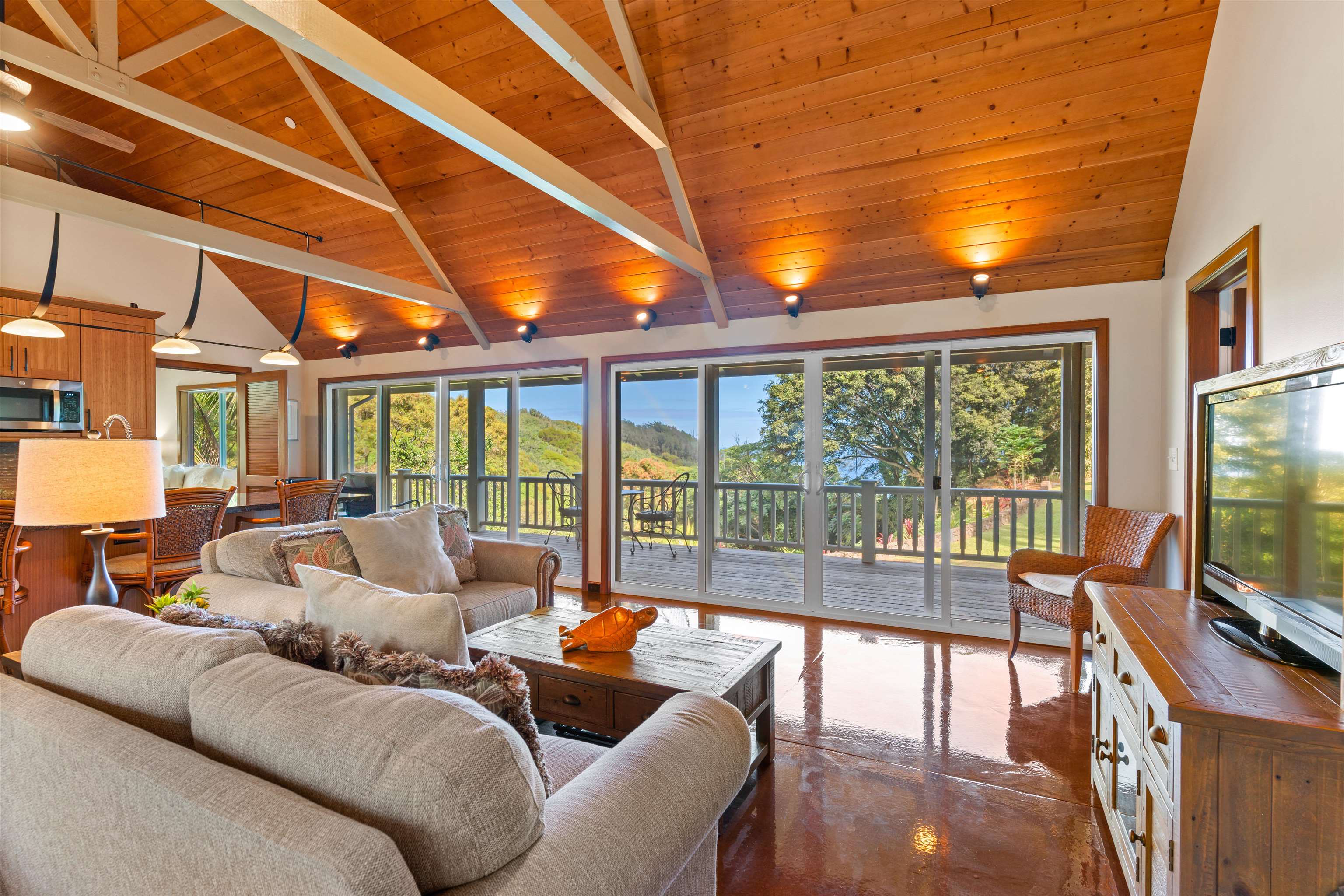 655 Kulike Road, Unit B Haiku, HI 96708 - Photo 8 of 38 a living room with furniture a flat screen tv and a large window