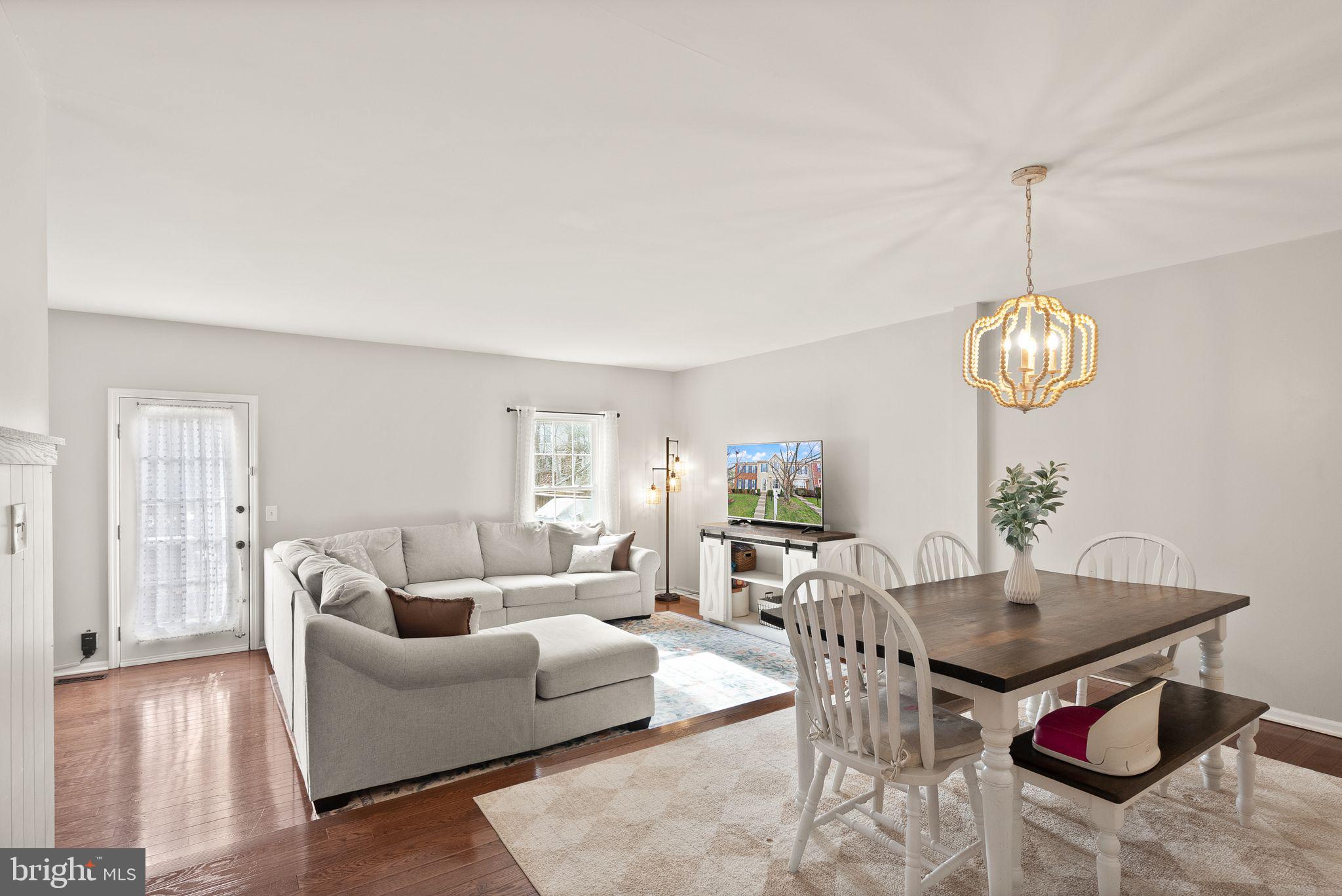 6020 Kestner Circle Alexandria, VA 22315 - Photo 14 of 59 a living room with furniture a chandelier and a dining table