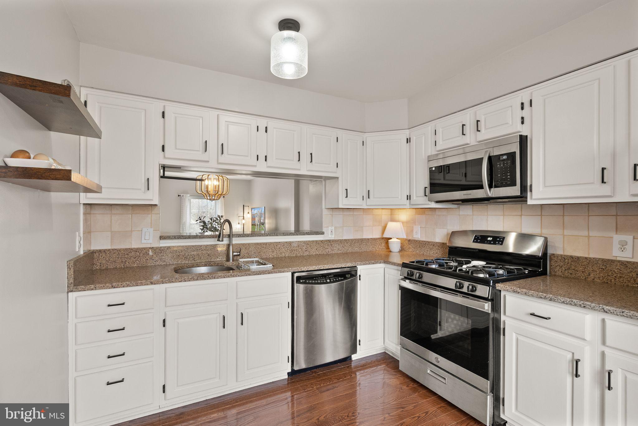 6020 Kestner Circle Alexandria, VA 22315 - Photo 8 of 59 a kitchen with granite countertop white cabinets white stainless steel appliances and a sink