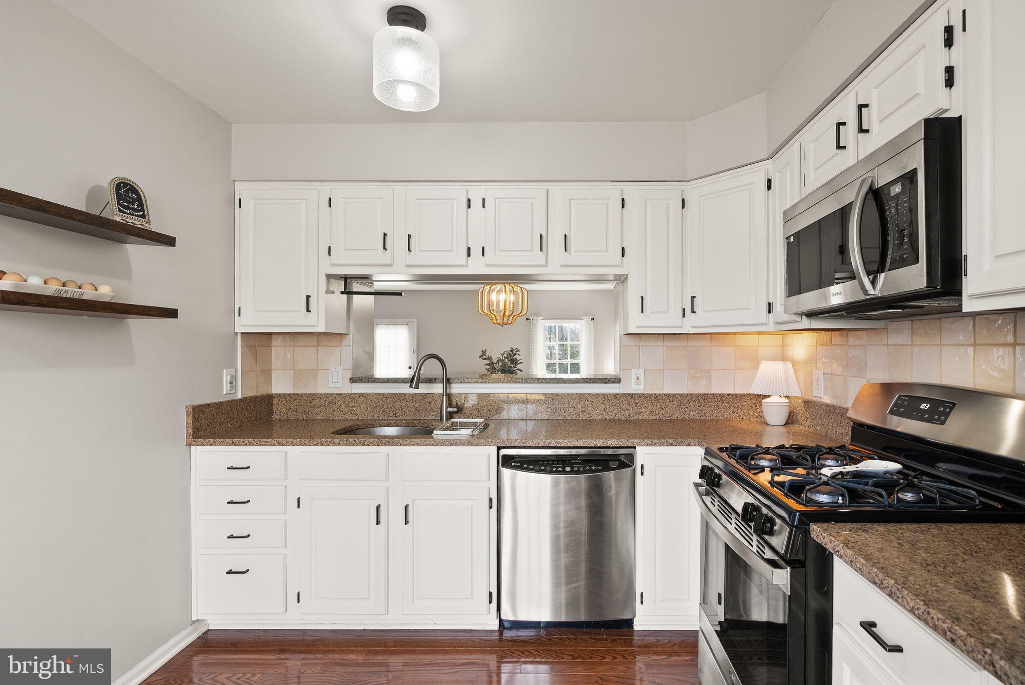 6020 Kestner Circle Alexandria, VA 22315 - Photo 9 of 59 a kitchen with granite countertop a stove and a sink