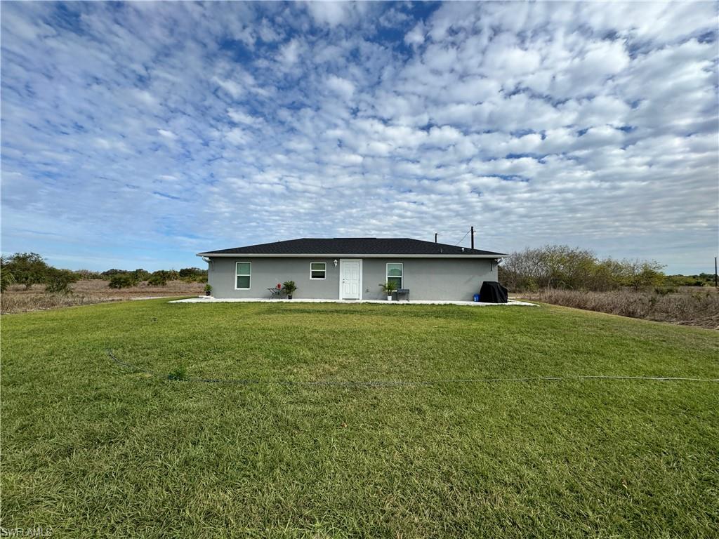 108 Dublin Circle LaBelle, FL 33935 - Photo 11 of 12 a backyard of a house with lots of green space and mountain view