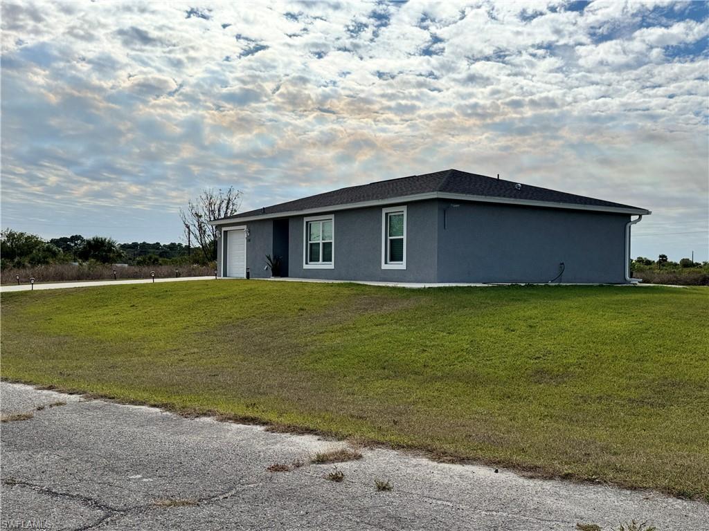 108 Dublin Circle LaBelle, FL 33935 - Photo 2 of 12 a house with a yard in front of it