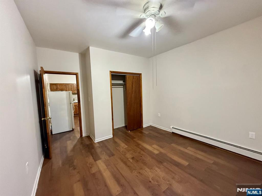 239-243 Harrison Avenue, Unit 10 Harrison, NJ 07029 - Photo 2 of 6 an empty room with closet and a chandelier fan