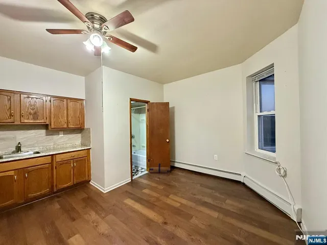 a view of a kitchen with a sink and a cabinet