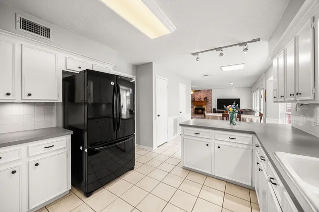 a kitchen with granite countertop a refrigerator and a sink
