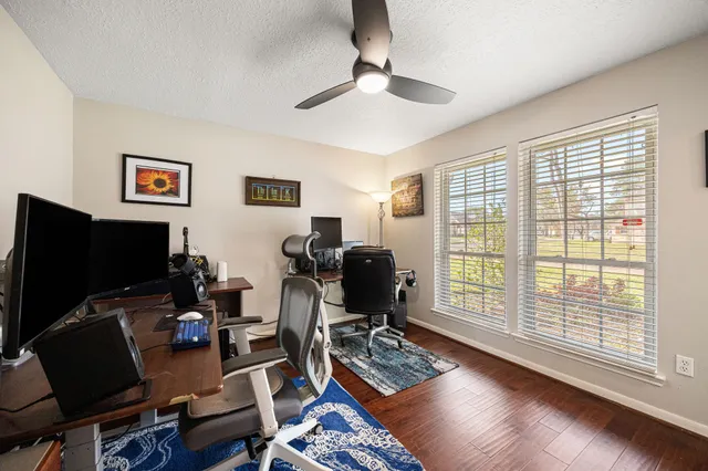 a view of a workspace with furniture and a window