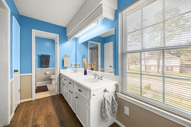 a bathroom with a double vanity sink and a large mirror