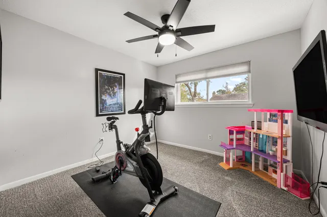 a room with gym equipment and a flat screen tv