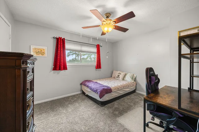 a bedroom with a bed and a chandelier