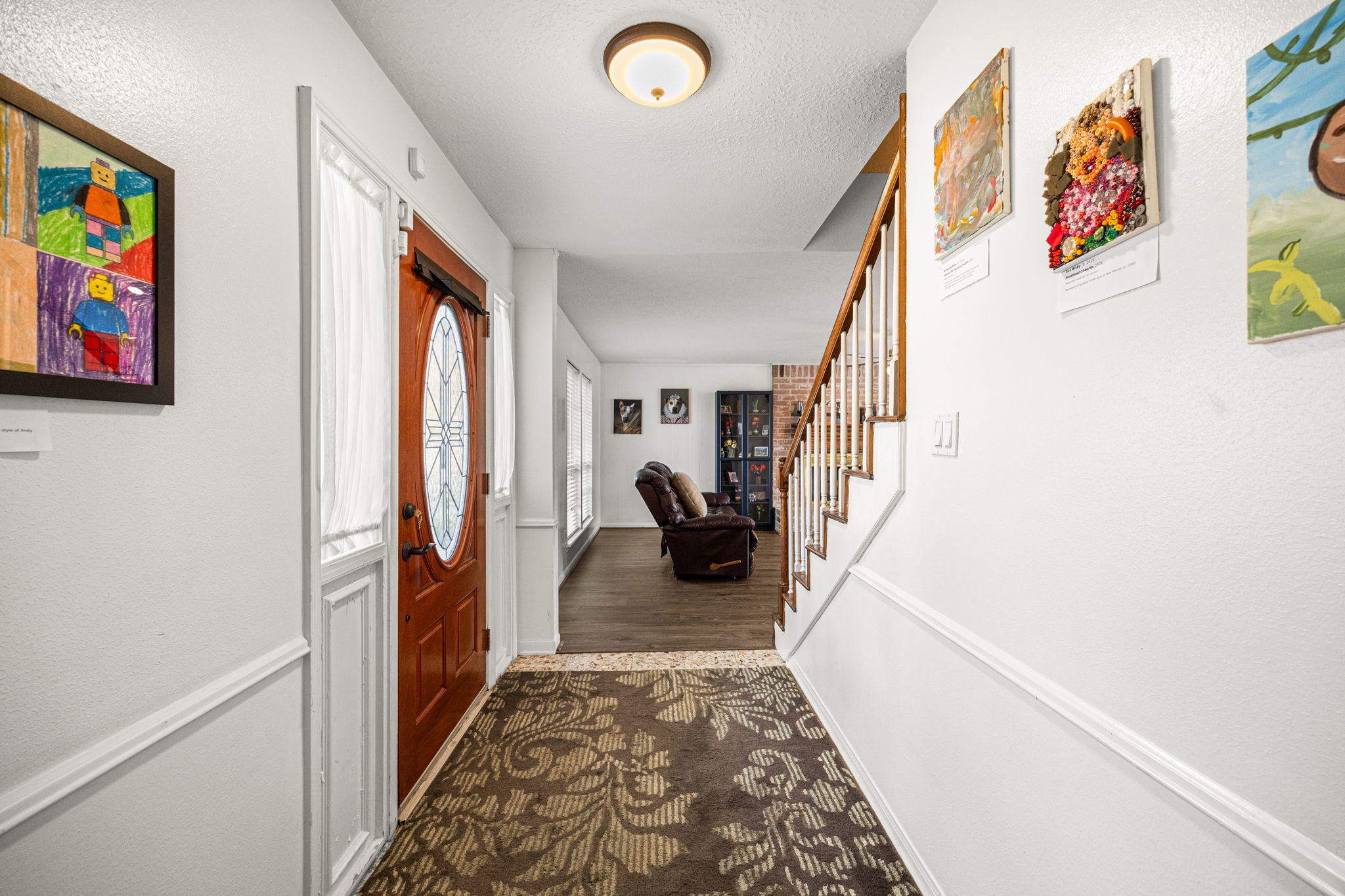 7023 Rosebrook Circle Spring, TX 77379 - Photo 5 of 29 a hallway with a flower pot and a bookshelf