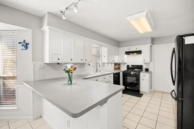 a kitchen with stainless steel appliances a refrigerator sink and cabinets