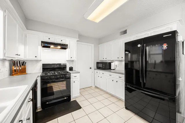 a kitchen with stainless steel appliances a refrigerator stove and sink